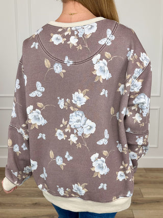 Dark brown crewneck long-sleeve sweatshirt with blue floral and butterfly print, back