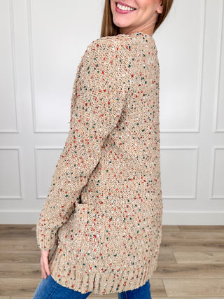 Tan knit long-sleeve cardigan with speckled texture, ribbed cuffs and hem