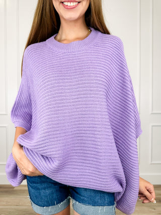 Lilac knit poncho top with crew neckline and flowy 3/4 dolman sleeves