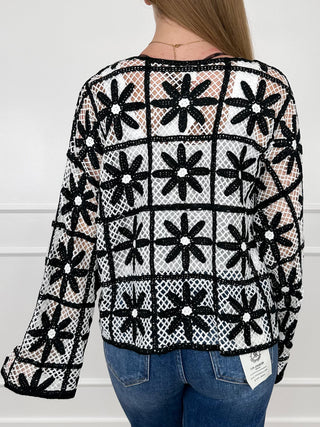Black and white patterned knit long sleeve top with crew neck and grid print
