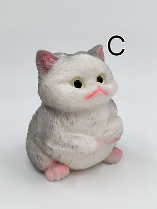 White plush squishy cat with green eyes, pink paws, and blush-gray fur
