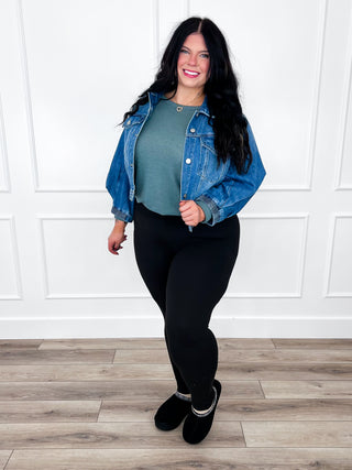Medium-wash cropped denim jacket with 3/4 sleeves, button-front, and chest pockets