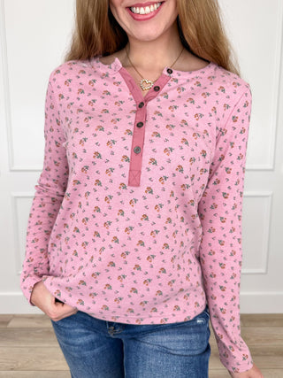 Pink ribbed long-sleeve henley top with small floral print and button placket