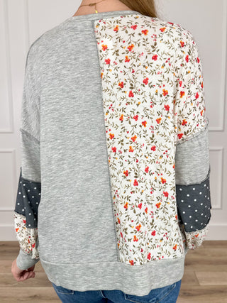Long sleeve knit top with back grey solid panel and floral sleeve patch