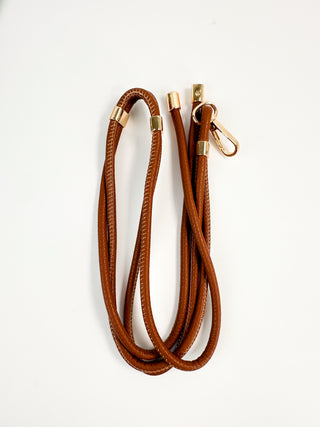 Brown faux leather lanyard with gold end clips and looped strap