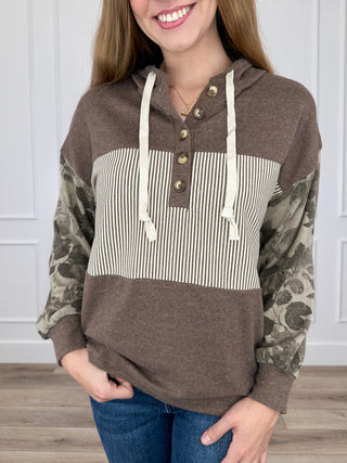 Brown hooded long-sleeve top with striped center panel, camo sleeves, front buttons