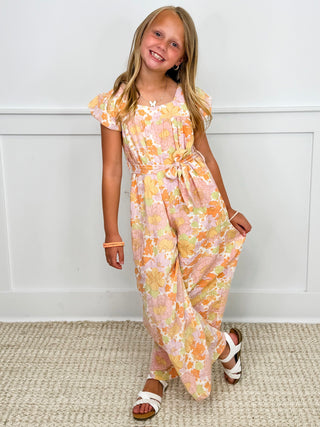 Kids cream floral jumpsuit with puff sleeves and bow tie at the waist