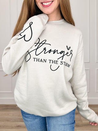 Oat long-sleeve crewneck sweatshirt with 'Stronger than the storm' front graphic