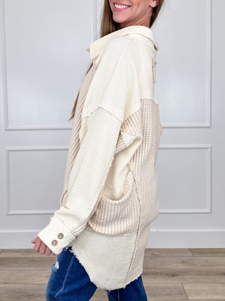 Cream hooded tunic top with textured knit, long sleeves, button placket