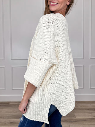 Ivory textured knit cardigan with loose 3/4 sleeves and side slits