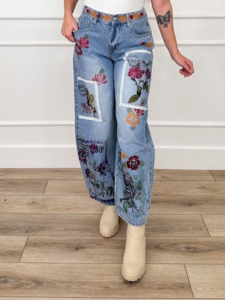 High-rise barrel-leg jeans, medium wash denim with colorful collage patchwork