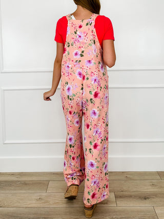Pink floral printed overalls with adjustable straps and wide straight legs