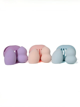 Makeup blending sponge set with purple, pink, and blue pods and grooved applicator
