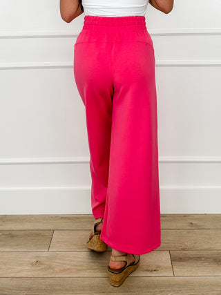 Bright pink high-rise wide-leg bottoms, back view, elastic drawstring waist