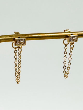 Gold chain drop earrings with square charm and dangling links, gold-tone finish.