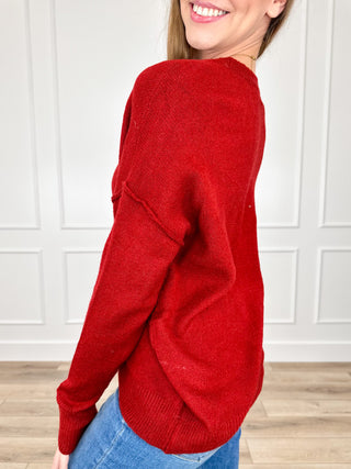 Red knit long-sleeve sweater with crew neck and ribbed hem
