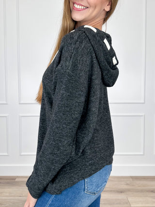 Dark heather knit hooded long-sleeve top with white drawstring ties, side view.