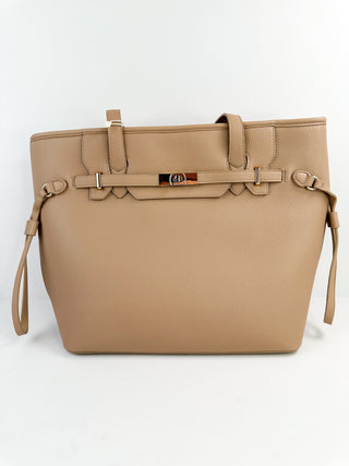 Beige faux leather tote bag with top handles, side straps, and front buckle detail