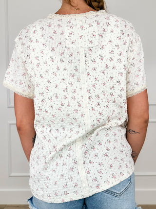 Ivory ribbed short-sleeve top with small floral print, relaxed back view