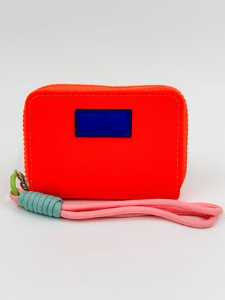 Red mini wallet with dark blue label and pink wrist strap
