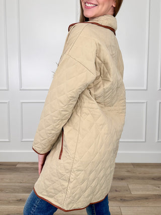 Sand quilted long-sleeve jacket, full-zip front and red-trim cuffs, side view
