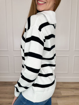 White knit quarter-zip sweater with black striped pattern, long sleeves, side view