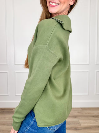 Green long-sleeve knit sweater with half-zip placket and ribbed cuffs