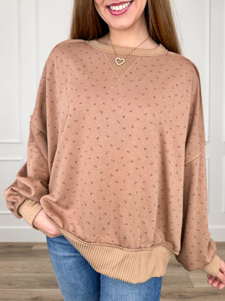 Long sleeve knit top with allover dot pattern, crew neck, and ribbed trim.
