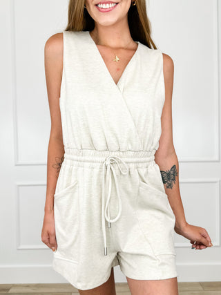 Heathered knit romper in oatmeal, V-neck front with drawstring waist and side pockets.
