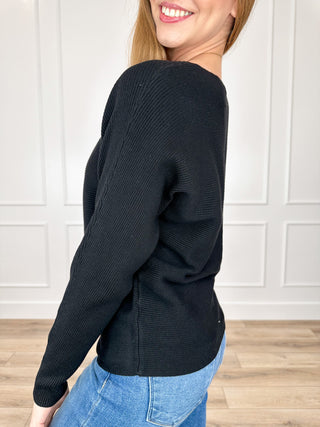 Black ribbed long-sleeve crewneck top, side view with fitted sleeve