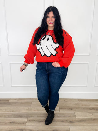 Orange knit long-sleeve sweater with black-and-white graphic and crew neckline