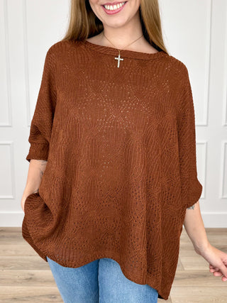 Rust brown knit short-sleeve poncho top with textured open-stitch pattern