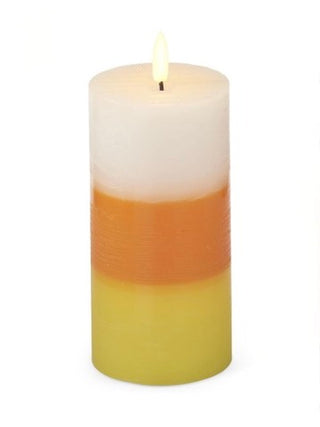LED pillar candle with layered white, orange, and yellow wax; lit flame
