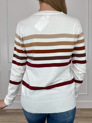 Ombre stripe knit sweater back view, crew neck; white with rust, tan, maroon bands