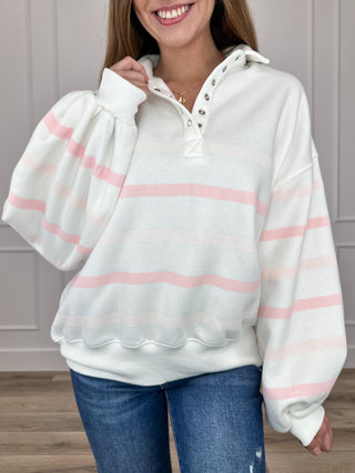 White long-sleeve sweatshirt with pink and mint striped bands and half-button neckline