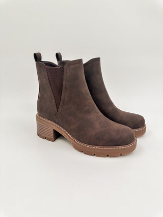Dark brown faux leather ankle booties with side elastic panels and stacked block heel.