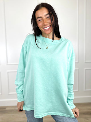 Mint green long-sleeve crewneck cotton-blend top with relaxed, curved hem