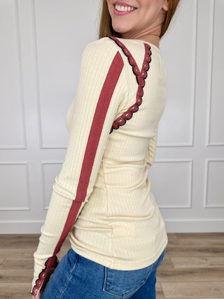 Cream ribbed long-sleeve top with maroon embroidered trim panels