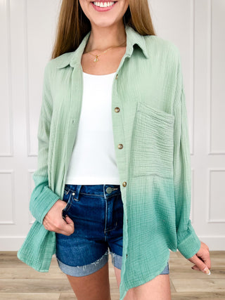 Long sleeve cotton button-up top in mint green, collared with front buttons and chest pocket.