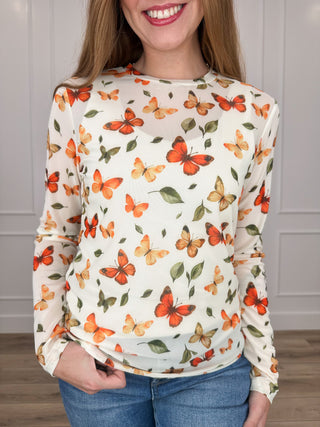 Cream sheer mesh long-sleeve top with allover butterfly floral print and round neckline