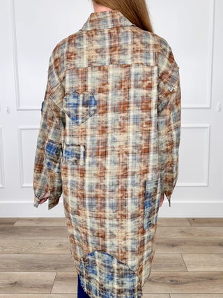 Plaid long-sleeve button-up shirt, open back view with blue patch accents