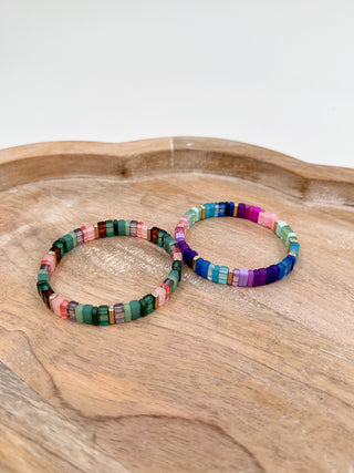 Multicolor beaded bracelet pair with green, pink, blue, purple and white cube beads