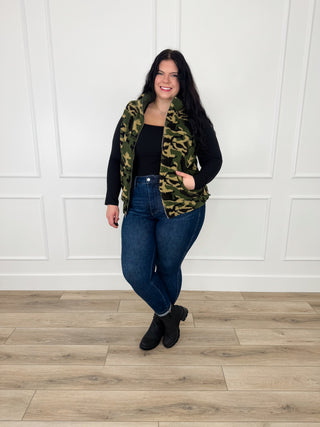 Green and black camouflage-style long sleeve top with V-neckline