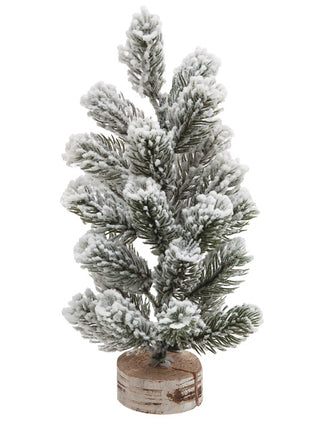 White faux pine tree decor on wooden base, tall tiered snow-covered branches