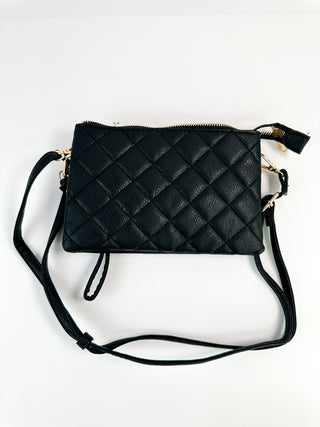 Black quilted faux-leather crossbody bag with zip top and shoulder strap