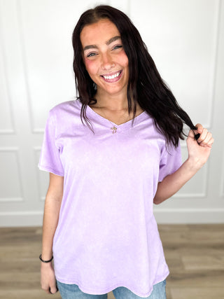 Purple V-neck short-sleeve cotton top with relaxed fit and soft drape.