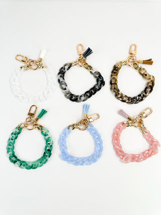 Assorted colored chain wristlet keychains set with gold clasps and tassels