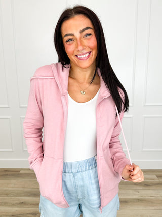 Pink full-zip long sleeve hoodie with front pockets, worn open over a tank