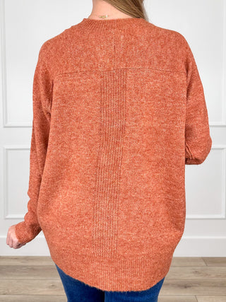 Rust orange knit mock-neck sweater top with long sleeves, back view