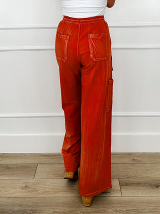 High-rise wide-leg cargo pants in rust orange with patch pockets and elastic drawstring waist